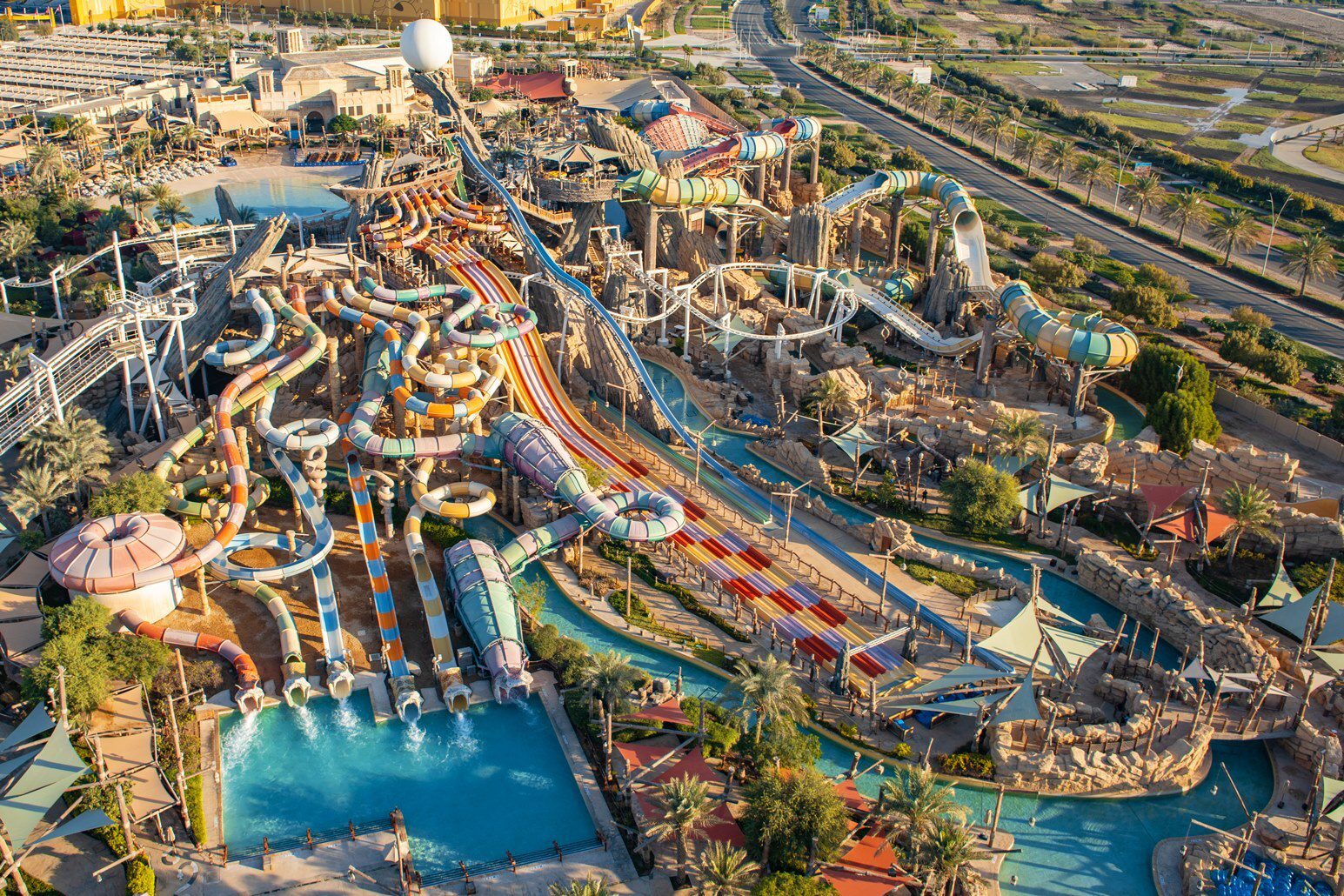 Aerial photograph of Yas Waterworld, showing numerous colorful waterslides, pools, and surrounding landscape.